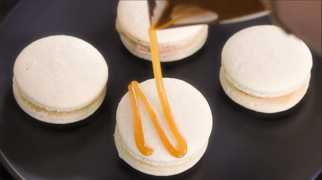 caramel drizzle on apple crisp macarons